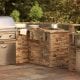 Outdoor kitchen with BBQ pit, mini fridge, stove top, faucet and more.